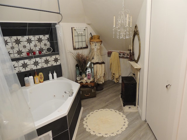 bathroom featuring plus walk in shower and hardwood / wood-style flooring