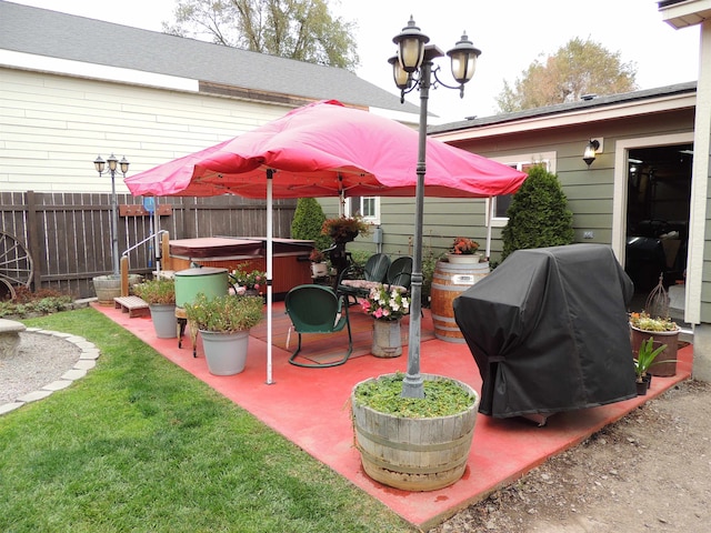 view of patio featuring a hot tub and a grill