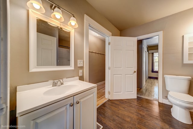 bathroom with vanity, hardwood / wood-style floors, and toilet