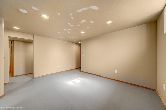 unfurnished room with a textured ceiling