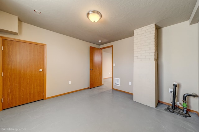 unfurnished room featuring a textured ceiling