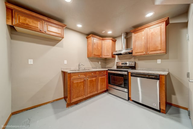 kitchen featuring wall chimney exhaust hood, sink, and stainless steel appliances