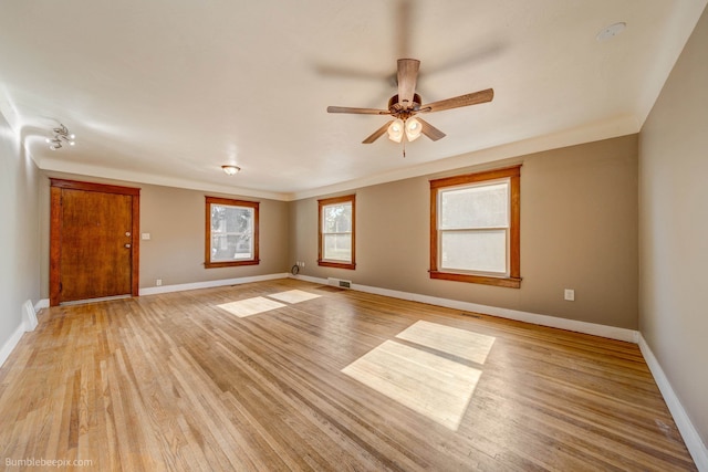 empty room featuring ceiling fan, ornamental molding, and light hardwood / wood-style floors