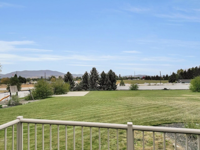 view of yard featuring a mountain view and a balcony