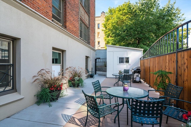 view of patio / terrace featuring area for grilling and a storage shed