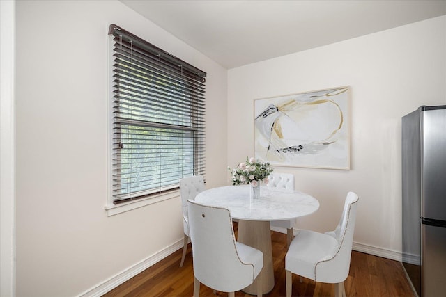 dining space with dark hardwood / wood-style floors