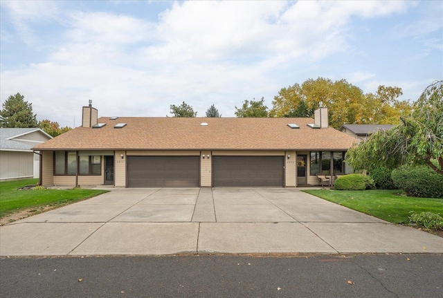 ranch-style house featuring a front yard and a garage