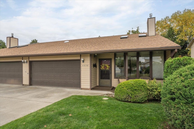 ranch-style home with a garage and a front yard