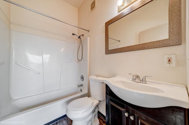 full bathroom featuring bathing tub / shower combination, toilet, and vanity