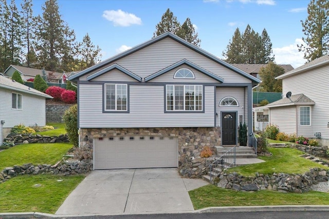 raised ranch with a front lawn and a garage