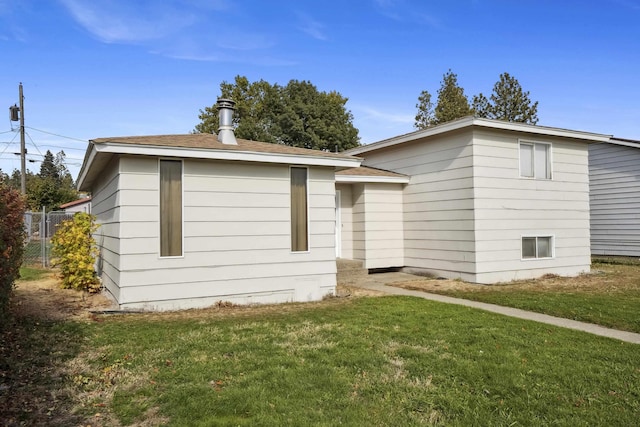 view of property exterior featuring a lawn