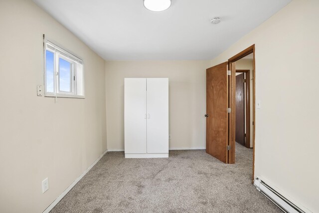 carpeted empty room with electric panel and a baseboard heating unit