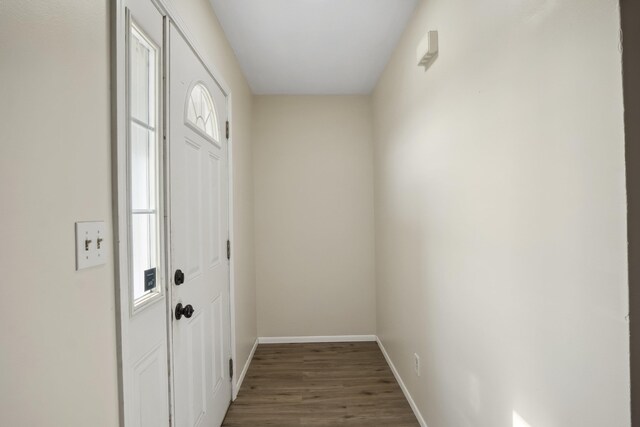 hallway with light hardwood / wood-style floors