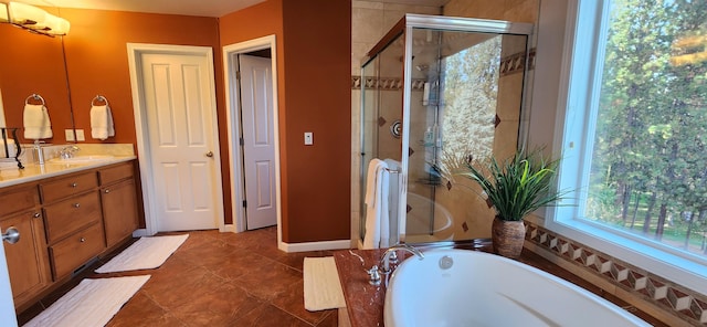 bathroom with tile patterned flooring, shower with separate bathtub, and vanity