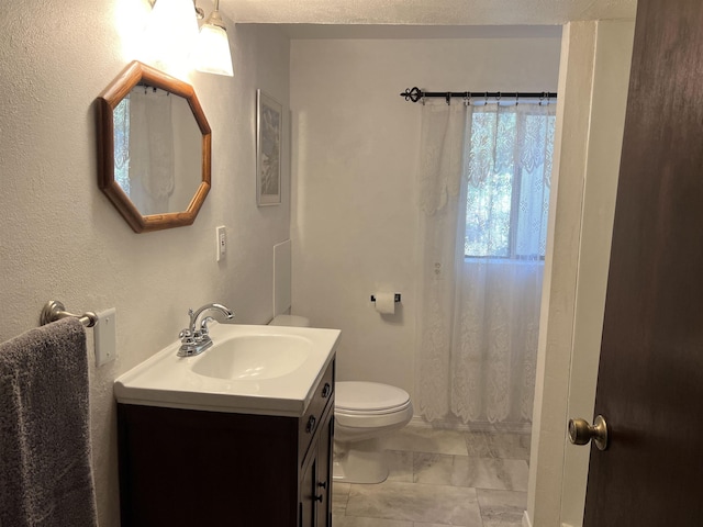 full bathroom with vanity, marble finish floor, and toilet