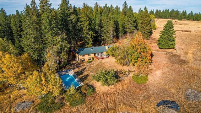 birds eye view of property with a forest view