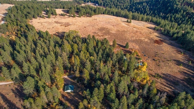 birds eye view of property featuring a view of trees
