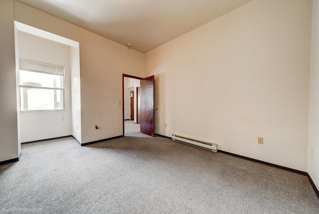 carpeted empty room with baseboard heating