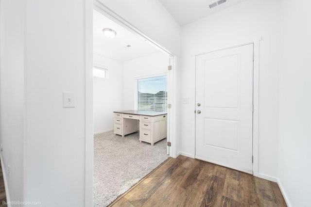 hallway with dark hardwood / wood-style flooring