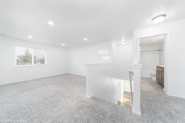 carpeted spare room featuring a textured ceiling