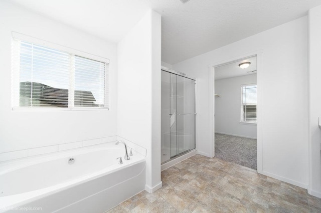 bathroom featuring separate shower and tub