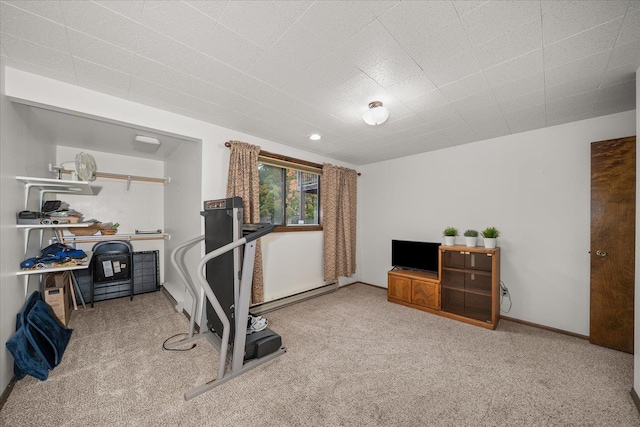 exercise area featuring a baseboard radiator and carpet