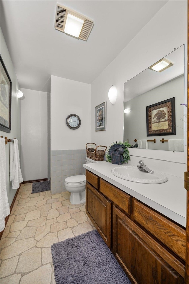 bathroom with vanity, toilet, and tile patterned flooring