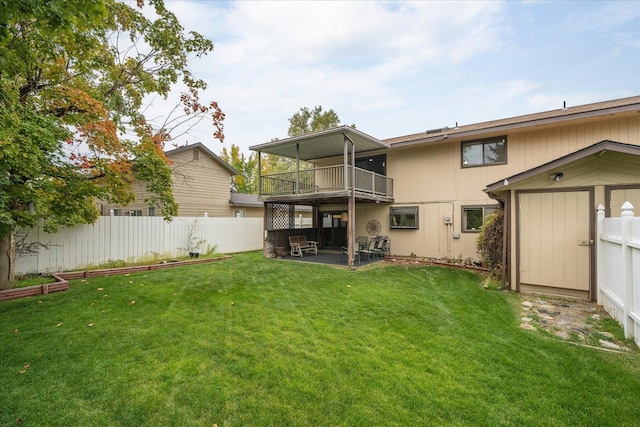 rear view of property featuring a yard, a shed, and a patio area