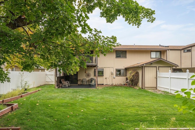 rear view of property featuring a patio area and a lawn