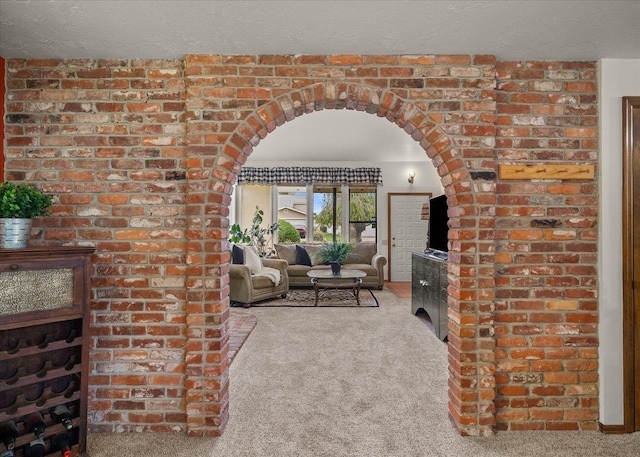 carpeted living room with a textured ceiling