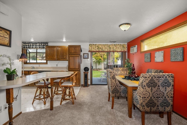 carpeted dining area featuring a wall mounted air conditioner and a textured ceiling