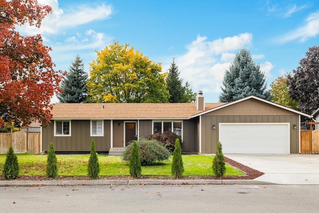 single story home with a garage and a front lawn