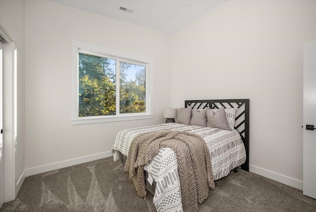 bedroom with dark colored carpet