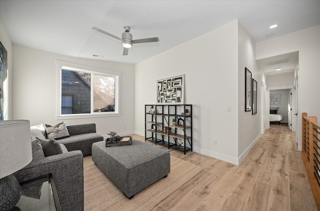 living room featuring light wood-type flooring and ceiling fan