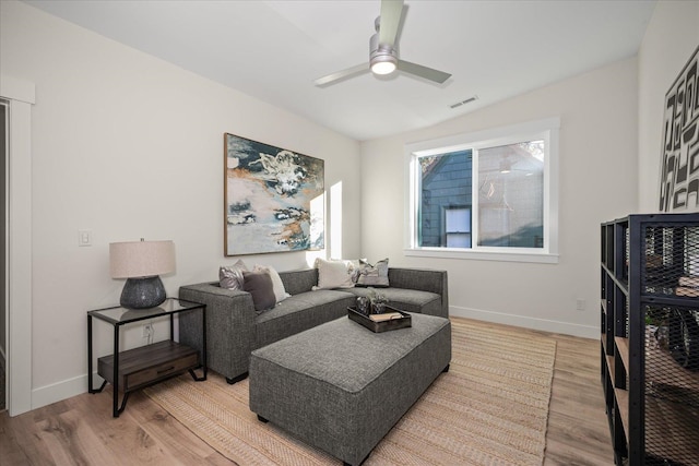 living room featuring light wood-type flooring and ceiling fan