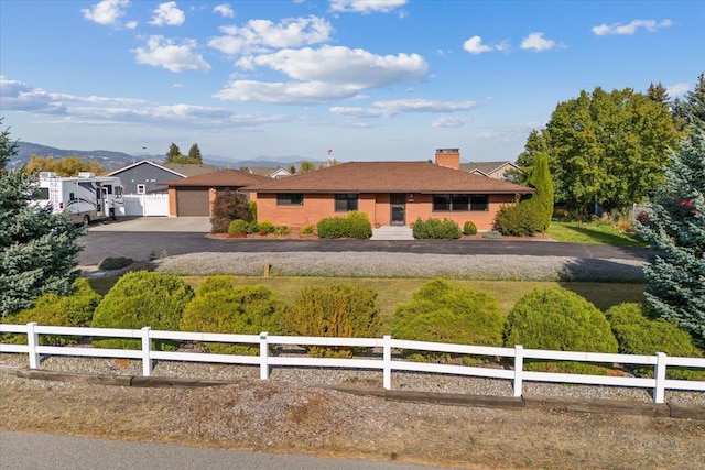 single story home featuring a mountain view and a garage