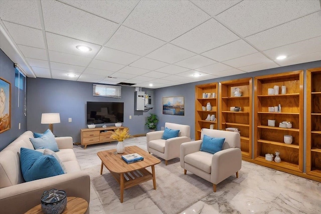 living room featuring a drop ceiling