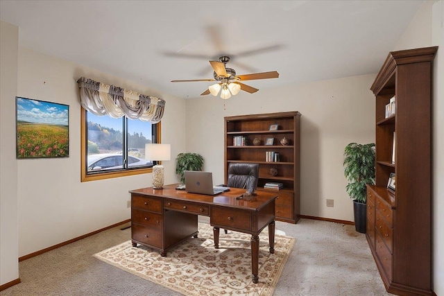 carpeted home office with ceiling fan