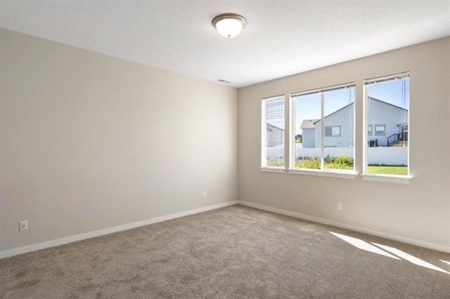 empty room with light colored carpet