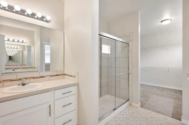 bathroom with vanity and a shower with door