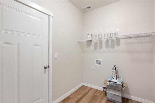 laundry room with hardwood / wood-style floors and washer hookup