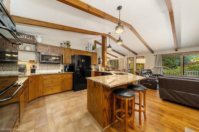 kitchen with tasteful backsplash, sink, lofted ceiling with beams, black refrigerator with ice dispenser, and decorative light fixtures