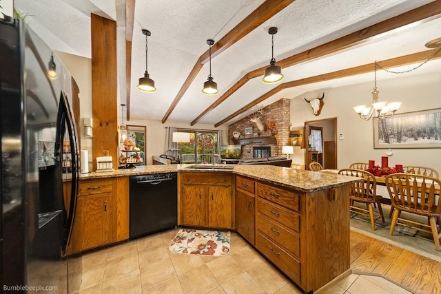 kitchen with pendant lighting, lofted ceiling with beams, black appliances, and kitchen peninsula