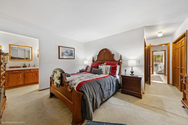 carpeted bedroom featuring ensuite bath