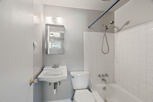 full bathroom with tiled shower / bath, sink, and toilet