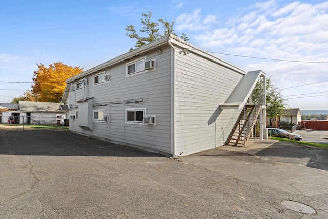 view of side of home featuring a wall mounted AC