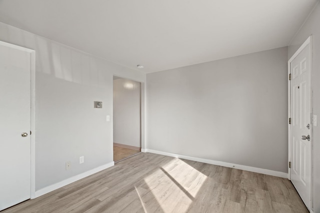 unfurnished room with light wood-type flooring