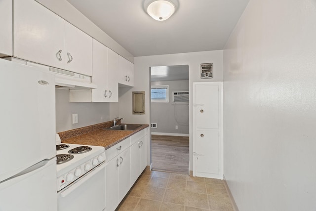 kitchen featuring white appliances, an AC wall unit, sink, and white cabinets