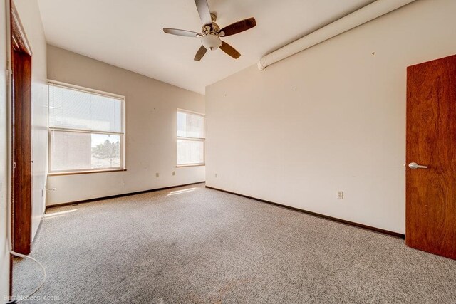 carpeted empty room with lofted ceiling and ceiling fan