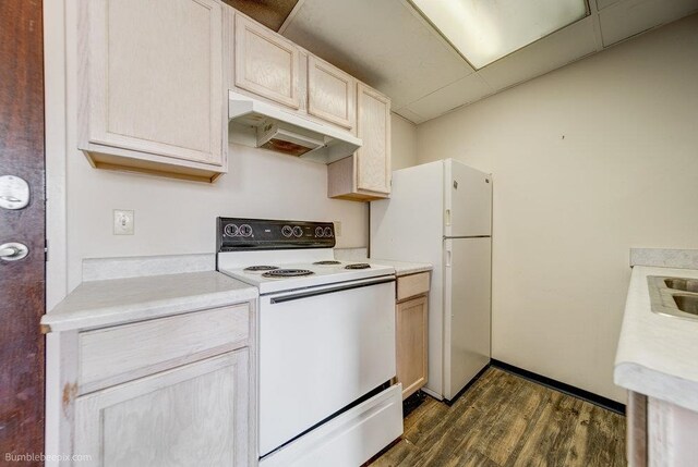 kitchen with white appliances, dark hardwood / wood-style flooring, and light brown cabinets